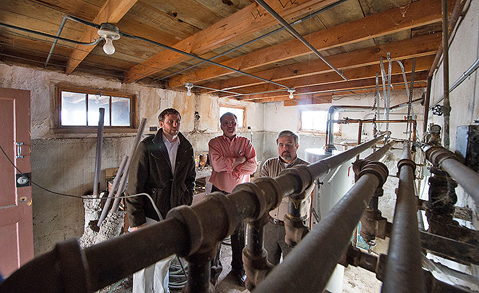 (left to right) NREL's Jesse Dean, Wally Piccone from the City of Lakewood, and NREL's Frank Rukavina assess the utility room: at the City of Lakewood's Graham House. NREL is coordinating a joint effort with the City of Lakewood and Red Rocks Community College to audit the Graham House and make suggestions for sustainable and energy-efficient modifications. The property was donated to the City and is used for public meetings and events. Photograph courtesy of NREL by Dennis Schroeder